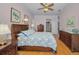 Bright bedroom featuring wood floors, ceiling fan, and matching furniture set at 4677 Aylesford Dr, Palm Harbor, FL 34685