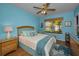 Bright bedroom with blue walls, wood floors and a ceiling fan at 4677 Aylesford Dr, Palm Harbor, FL 34685