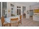 Bright breakfast nook features tile floors, table with seating, and view to the lanai at 4677 Aylesford Dr, Palm Harbor, FL 34685
