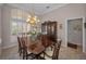 Elegant dining room featuring a wooden table, chairs, chandelier, and a china cabinet at 4677 Aylesford Dr, Palm Harbor, FL 34685