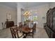 Elegant dining room with a wooden table, chairs, chandelier, and a china cabinet at 4677 Aylesford Dr, Palm Harbor, FL 34685