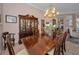 Elegant dining room with a wooden table, chairs, chandelier, and a china cabinet at 4677 Aylesford Dr, Palm Harbor, FL 34685