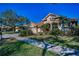 A beautiful single-Gathering home showing the manicured front yard and mature shade trees on a sunny day at 4677 Aylesford Dr, Palm Harbor, FL 34685