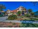 Charming home with red tile roof, a blue door and window shutters, and lush, mature landscaping at 4677 Aylesford Dr, Palm Harbor, FL 34685