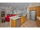Spacious kitchen with an island, stainless steel appliances, and open views to the living area at 4677 Aylesford Dr, Palm Harbor, FL 34685