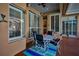 Covered lanai offers shuttered windows, dining table, and a decorative ceiling at 4677 Aylesford Dr, Palm Harbor, FL 34685