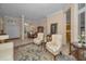 Spacious and bright living room featuring tile flooring, elegant furnishings, and a dining area in background at 4677 Aylesford Dr, Palm Harbor, FL 34685