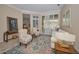 Cozy living room featuring tile flooring, natural light, and a seamless transition to other living spaces at 4677 Aylesford Dr, Palm Harbor, FL 34685