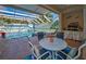 Inviting pool area with covered seating, a lanai, and lush backyard views at 4677 Aylesford Dr, Palm Harbor, FL 34685