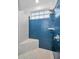 Modern shower with blue tiled wall, rainfall shower head, and mosaic tiled seat at 4677 Aylesford Dr, Palm Harbor, FL 34685