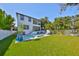 Well-maintained backyard showcasing a pool, lush lawn, and beautifully designed two-story house at 47 Adalia Ave, Tampa, FL 33606