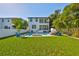 Spacious backyard features lush lawn, sparkling pool, a two-story house, and well-manicured landscaping at 47 Adalia Ave, Tampa, FL 33606