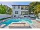 Stunning backyard oasis featuring a sparkling pool, fire pit, lush lawn, and outdoor living spaces at 47 Adalia Ave, Tampa, FL 33606
