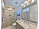 Modern bathroom with a glass shower, granite countertop, and tile flooring at 47 Adalia Ave, Tampa, FL 33606