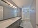 Bathroom features a large mirror, granite countertops, and a bathtub with a shower at 47 Adalia Ave, Tampa, FL 33606
