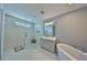 Bathroom with a walk-in shower, a marble floor, and a freestanding tub at 47 Adalia Ave, Tampa, FL 33606
