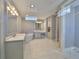 Bright bathroom features a soaking tub, double vanity, and a large glass shower at 47 Adalia Ave, Tampa, FL 33606