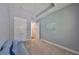 Bedroom offers comfortable blue couch, white closet, and a decorative sailboat painting on the wall at 47 Adalia Ave, Tampa, FL 33606
