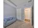 Comfortable bedroom features blue walls, plush carpet, and a cozy couch with decorative pillows at 47 Adalia Ave, Tampa, FL 33606