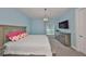 Comfortable bedroom features a television set, white comforter, and a chest of drawers at 47 Adalia Ave, Tampa, FL 33606