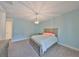 Cozy bedroom features a chandelier and a grey dresser with a comfortable bed at 47 Adalia Ave, Tampa, FL 33606