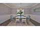 Elegant dining room featuring wainscoting, modern lighting, and a stylish rug at 47 Adalia Ave, Tampa, FL 33606