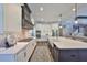 Modern kitchen with white cabinets, stainless steel appliances, a stylish range hood, and an open layout at 47 Adalia Ave, Tampa, FL 33606