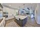 Bright, modern kitchen featuring white cabinets, a large island with seating, and an open view to the living area at 47 Adalia Ave, Tampa, FL 33606