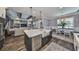 Open concept kitchen flowing into the living room featuring a center island with a farmhouse sink at 47 Adalia Ave, Tampa, FL 33606