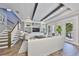 Bright living room featuring a custom built-in entertainment center, wood floors, and a staircase at 47 Adalia Ave, Tampa, FL 33606