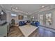 Comfortable living room featuring a blue sectional couch, recessed lighting, and access to the outdoors at 47 Adalia Ave, Tampa, FL 33606