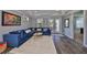 Living room featuring hardwood floors, a blue sofa, and sliding doors that lead to a balcony at 47 Adalia Ave, Tampa, FL 33606