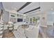 Open-concept living room features built-in shelving, beamed ceilings and French doors leading to the outside at 47 Adalia Ave, Tampa, FL 33606