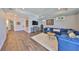 Comfortable living room with a blue sofa, wood floors, and a stylish area rug at 47 Adalia Ave, Tampa, FL 33606