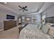 Bedroom with a tray ceiling, a ceiling fan, two windows, and a television on the wall at 47 Adalia Ave, Tampa, FL 33606