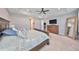 Large main bedroom with a trey ceiling, ceiling fan, windows, and an exit doorway at 47 Adalia Ave, Tampa, FL 33606
