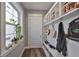 Convenient mudroom area with bench, hooks, and storage for shoes and coats at 47 Adalia Ave, Tampa, FL 33606