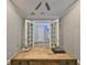 Office featuring a wooden desk, neutral walls, and double French doors leading to the entry way at 47 Adalia Ave, Tampa, FL 33606