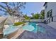 Inviting pool area featuring a cozy lounge chair, lush landscaping, and serene backyard privacy at 47 Adalia Ave, Tampa, FL 33606