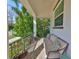 Relax on the cozy front porch with comfortable seating and charming decorative pillows at 47 Adalia Ave, Tampa, FL 33606