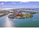 Stunning aerial view showcasing the waterfront community with lush landscaping and boat access at 530 Sandy Hook Rd, Treasure Island, FL 33706