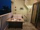 Balcony with a cozy seating area, gas fire pit, and scenic evening views of the waterfront at 530 Sandy Hook Rd, Treasure Island, FL 33706