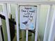 Close up of a fun wall decor sign on the balcony of the waterfront townhome at 530 Sandy Hook Rd, Treasure Island, FL 33706