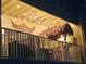Balcony with decorative lights and thatched umbrellas at 530 Sandy Hook Rd, Treasure Island, FL 33706