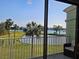 Enjoy the serene views of the lake, palm trees, and green spaces from this screened in balcony at 530 Sandy Hook Rd, Treasure Island, FL 33706