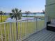 Relax on the balcony and take in the view of the lake, palm trees, and greenery at 530 Sandy Hook Rd, Treasure Island, FL 33706