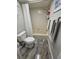 Bathroom featuring a toilet, shower/tub combination, tiled floors, and a sink with white cabinet storage at 530 Sandy Hook Rd, Treasure Island, FL 33706