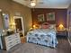 Spacious bedroom featuring stylish decor, a ceiling fan, and an ensuite bathroom at 530 Sandy Hook Rd, Treasure Island, FL 33706