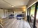 Bedroom with bunk beds, nautical decor, and access to a balcony at 530 Sandy Hook Rd, Treasure Island, FL 33706