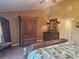 Bedroom featuring a large wardrobe, dresser, lamps and a tropical bedspread at 530 Sandy Hook Rd, Treasure Island, FL 33706